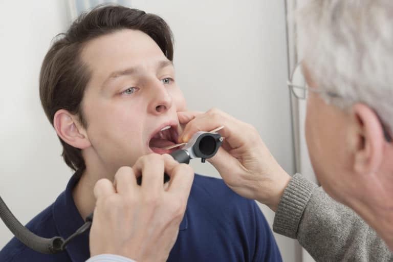 A patient having their throat examined by an otolaryng
