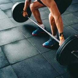 A person holding a barbell, weight lifting