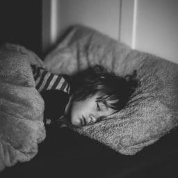 Little girl trying to sleep but her eyes are open