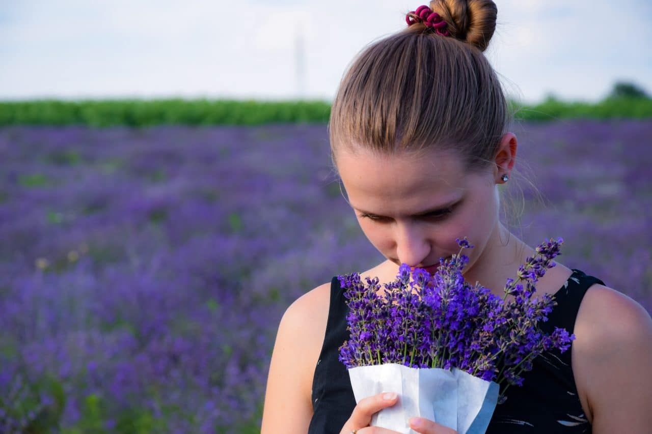 Woman smelling a bouquet of lavender