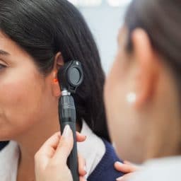 Otolaryngologist checking a patient's ear