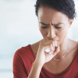 Woman coughing at work.