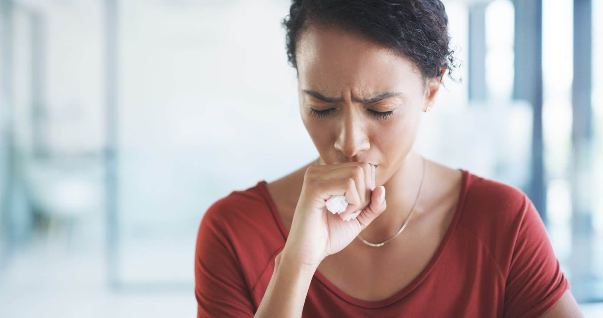Woman coughing at work.