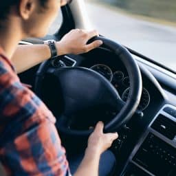 Close up of a man driving her car.