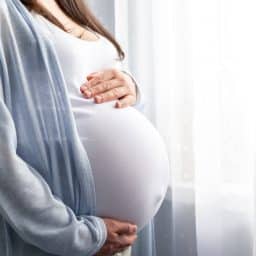 a close-up image of a pregnant woman's stomach