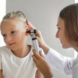 Young girl getting her ear checked for an infection