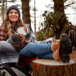 Woman having coffee on a chilly hiking trip.