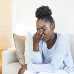 Woman with a sinus infection holding the bridge of her nose
