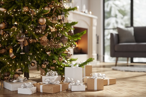 Close-up Of Christmas Tree And Gift Boxes In Living Room With Blurred Background