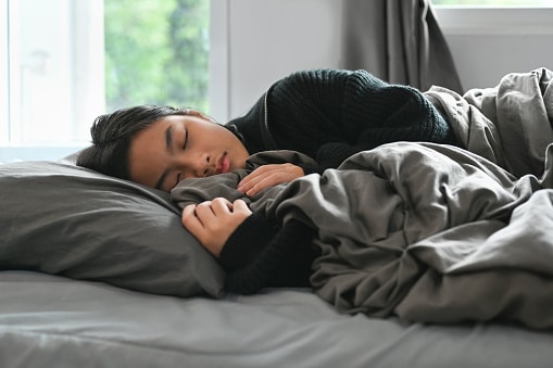 Young woman sleeping in her bed.